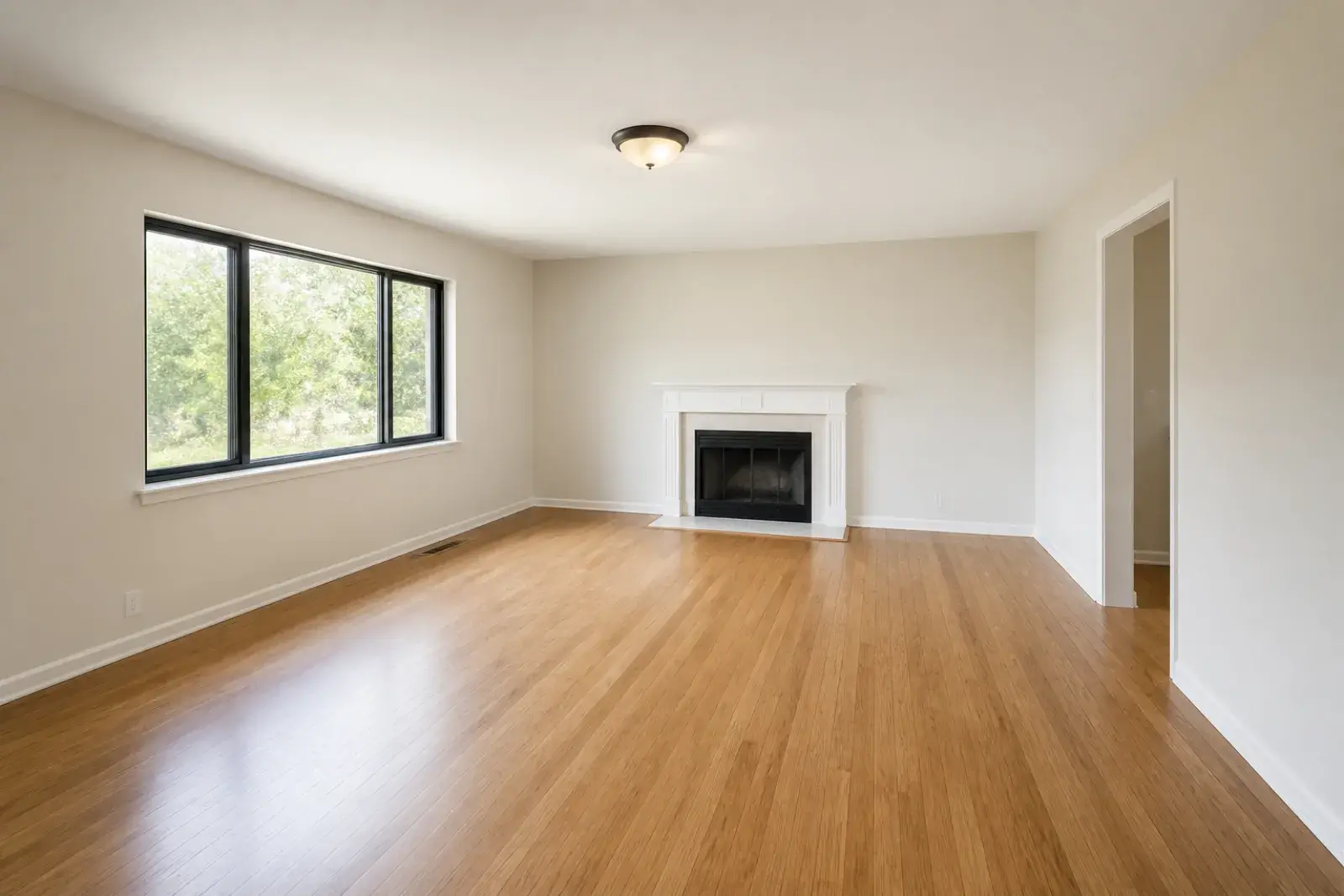 Warm-modern living-room virtual staging: Before — original empty room