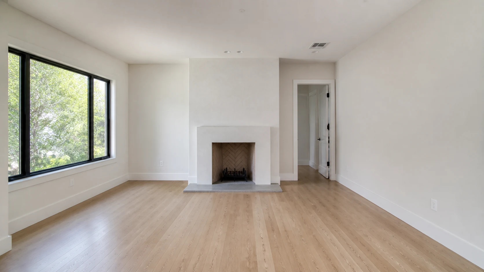 Warm-contemporary living-room virtual staging: Before — original empty room